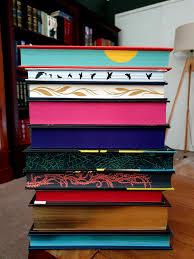 An image of a stack of books with hand painted edges.