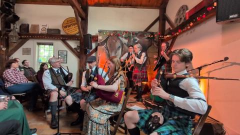 A photo of members of Pipes and Drums of NHSCOT.